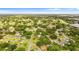 Aerial view of the home in a neighborhood setting with mature trees and landscaping at 107 Alachua Dr, Winter Haven, FL 33884