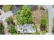 Aerial perspective of the home featuring mature trees and an expansive lot at 107 Alachua Dr, Winter Haven, FL 33884