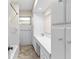 Well-lit bathroom showcasing a white vanity, tiled walls, and neutral flooring at 107 Alachua Dr, Winter Haven, FL 33884