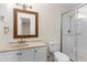 Well-lit bathroom featuring a glass-enclosed shower, framed mirror, and a neutral vanity with sink at 107 Alachua Dr, Winter Haven, FL 33884