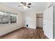Cozy bedroom with hardwood-style floors, closet space, and a window providing natural light at 107 Alachua Dr, Winter Haven, FL 33884