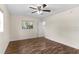 Bedroom features wood-look flooring, ceiling fan, and a window with natural light at 107 Alachua Dr, Winter Haven, FL 33884