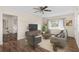 Inviting living room featuring a ceiling fan, hardwood floors and large windows for natural light at 107 Alachua Dr, Winter Haven, FL 33884