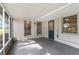 Enclosed porch with concrete floor, beadboard ceiling, screen windows and view of large green lawn at 107 Alachua Dr, Winter Haven, FL 33884