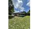 Private backyard oasis featuring a large screened-in pool and lush greenery at 299 Cobalt Dr, Kissimmee, FL 34758