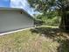 Spacious backyard featuring a screened-in pool area and mature trees for added privacy at 299 Cobalt Dr, Kissimmee, FL 34758