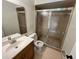 Bathroom featuring a vanity with a stainless steel faucet and a toilet next to a glass shower at 299 Cobalt Dr, Kissimmee, FL 34758
