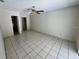 Spacious bedroom featuring tiled floors and a ceiling fan, with access to additional rooms at 299 Cobalt Dr, Kissimmee, FL 34758