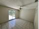 Bright bedroom with tile flooring, sliding glass door, and a ceiling fan at 299 Cobalt Dr, Kissimmee, FL 34758