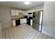 Eat-in kitchen featuring stainless steel appliances, white cabinets, and tile flooring at 299 Cobalt Dr, Kissimmee, FL 34758