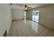 Bright living room with tile flooring, ceiling fan, and sliding glass doors at 299 Cobalt Dr, Kissimmee, FL 34758
