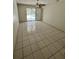 Bright living room featuring tiled floors, ceiling fan, and sliding glass doors to the outdoor pool at 299 Cobalt Dr, Kissimmee, FL 34758