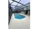 A refreshing covered pool, accompanied by a clean, well-maintained deck area for leisure at 299 Cobalt Dr, Kissimmee, FL 34758