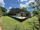 Beautiful in-ground pool with a full screen enclosure in a serene backyard setting at 299 Cobalt Dr, Kissimmee, FL 34758