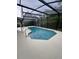 Inviting screened-in pool area with a clean, white deck and an enclosed space for outdoor enjoyment at 299 Cobalt Dr, Kissimmee, FL 34758