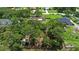 Large property with lush trees surrounding a home with a fenced in back yard at 4621 Musket Dr, Lakeland, FL 33810