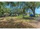 View of the spacious backyard with a storage shed and lots of shady spots at 4621 Musket Dr, Lakeland, FL 33810