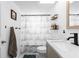 Clean bathroom with a ship-themed shower curtain, a modern sink, and a towel rack at 4621 Musket Dr, Lakeland, FL 33810