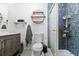 Bathroom featuring a shower with blue tiling, a toilet, and a vanity with storage at 4621 Musket Dr, Lakeland, FL 33810