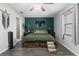 This bedroom features a green accent wall, wooden floors, and a ceiling fan for comfort and style at 4621 Musket Dr, Lakeland, FL 33810