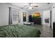 Cozy bedroom featuring wood-look floors, a large window, and a view into the connecting living space at 4621 Musket Dr, Lakeland, FL 33810