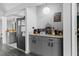Butler pantry featuring grey cabinets, stainless steel appliances, and stone countertops at 4621 Musket Dr, Lakeland, FL 33810