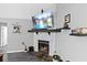 Close up of a stone fireplace with a wooden mantle and a television above the hearth at 4621 Musket Dr, Lakeland, FL 33810