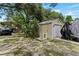 Detached garage with a roll-up door, plus a covered carport and yard at 4621 Musket Dr, Lakeland, FL 33810