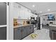 Modern kitchen with white cabinets, gray lower cabinets, and stainless-steel appliances at 4621 Musket Dr, Lakeland, FL 33810