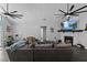 Inviting living room featuring a stone fireplace, vaulted ceilings, and modern ceiling fans at 4621 Musket Dr, Lakeland, FL 33810