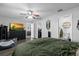 Spacious main bedroom with ensuite bathroom, walk-in closet, ceiling fan and modern decor; pet bed shown at 4621 Musket Dr, Lakeland, FL 33810