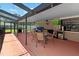 Spacious screened patio with a lounge area and grill, perfect for entertaining and outdoor living at 4621 Musket Dr, Lakeland, FL 33810