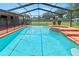 Large screened-in pool with attached spa provides private backyard oasis at 4621 Musket Dr, Lakeland, FL 33810