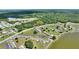 Expansive aerial view of a lakeside community, showcasing lush landscaping and serene water views in a park-like setting at 523 Club Cir, Lakeshore, FL 33854