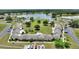Aerial view of a condo community near a lake with mature trees and lush landscaping at 523 Club Cir, Lakeshore, FL 33854
