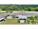An aerial view showcasing the back of the property, featuring a landscaped yard and screened-in patio at 523 Club Cir, Lakeshore, FL 33854