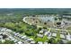Aerial view of the community and surrounding area, showcasing lake and lush landscapes at 523 Club Cir, Lakeshore, FL 33854