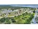 Aerial view of a community near a lake, highlighting its mature landscaping and convenient parking at 523 Club Cir, Lakeshore, FL 33854