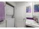 Tidy bathroom with stackable washer/dryer, updated fixtures, and a modern vanity sink at 523 Club Cir, Lakeshore, FL 33854