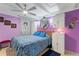 Bright bedroom features a comfortable bed, ceiling fan, and mirrored closet at 523 Club Cir, Lakeshore, FL 33854