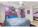 Bright bedroom showcases a comfortable bed, mirrored closet, and purple accent wall at 523 Club Cir, Lakeshore, FL 33854