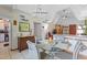 Bright dining room with chandelier lighting and vaulted ceilings at 523 Club Cir, Lakeshore, FL 33854