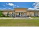 Charming duplex featuring a well-manicured lawn and cozy front porch seating at 523 Club Cir, Lakeshore, FL 33854