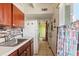 Bright kitchen features stainless steel appliances, white cabinets and colorful backsplash at 523 Club Cir, Lakeshore, FL 33854