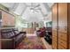 Relaxing living room with vaulted ceilings, colorful rug, and a cozy seating area at 523 Club Cir, Lakeshore, FL 33854