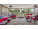 Spacious sunroom with tile floor and ample seating with a beautiful backyard view at 523 Club Cir, Lakeshore, FL 33854