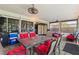 Enclosed patio featuring a glass top dining table, comfortable seating, and cooling ceiling fans at 523 Club Cir, Lakeshore, FL 33854