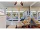 Enclosed sunroom with comfortable seating and expansive windows for natural light and relaxation at 523 Club Cir, Lakeshore, FL 33854