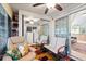 Bright sunroom with comfortable seating, ceiling fans, and sliding glass doors leading outdoors at 523 Club Cir, Lakeshore, FL 33854