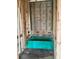 New construction bathroom with a bright blue tub, concrete walls, and wood frame at 5724 Haystack Drive, St Cloud, FL 34771
